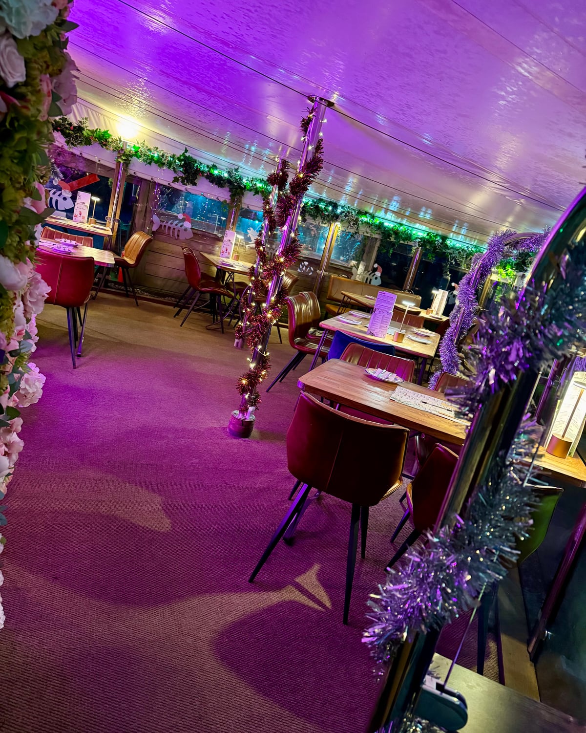 The Bank at Bude riverside dining room lit purple and decorated for Christmas party nights