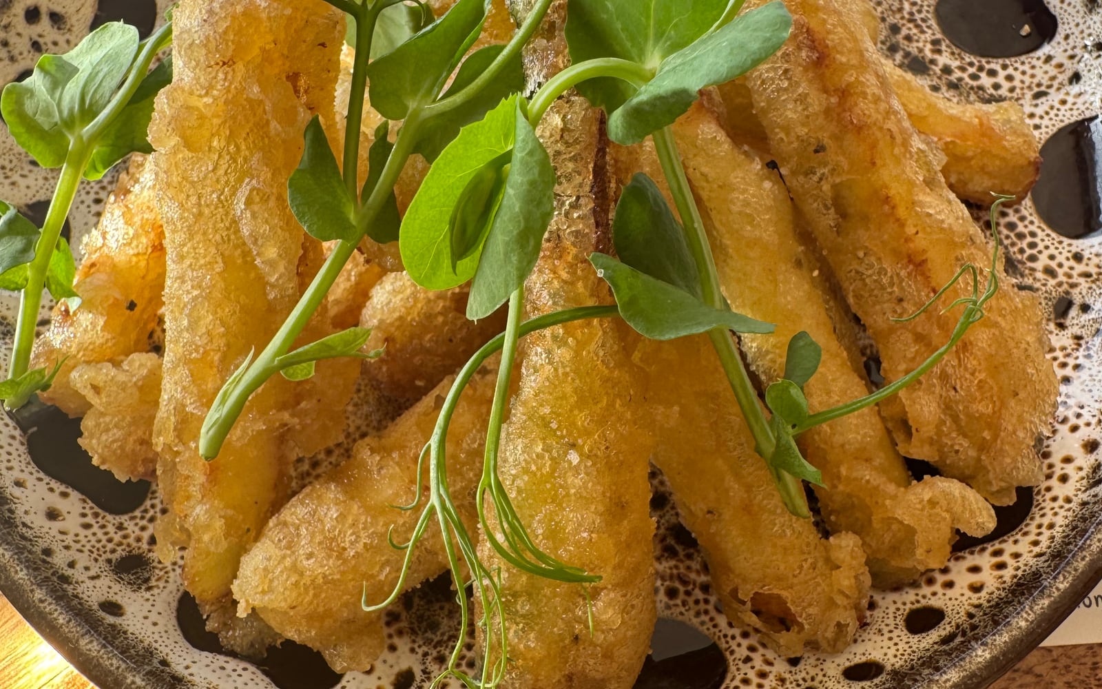 Crisp tempura courgette fries topped with pea shoots at The Bank at Bude