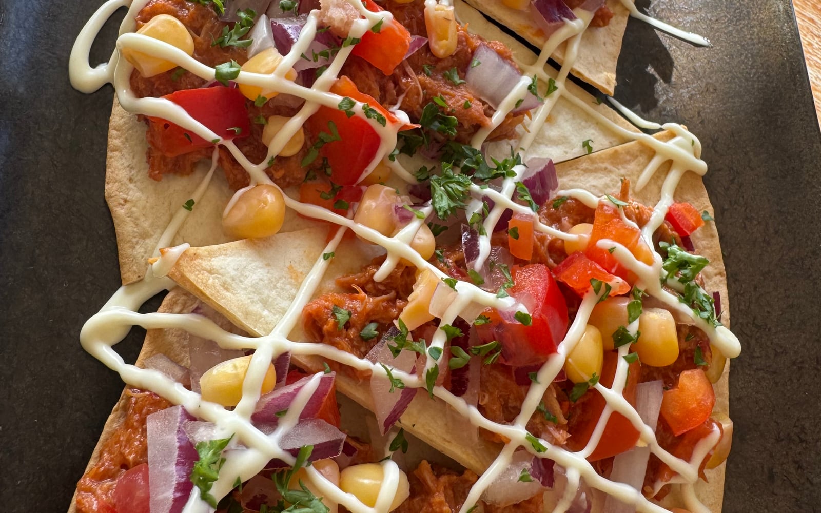 Pulled duck tostadas with corn salsa, peppers and citrus mayo on homemade tortilla at The Bank at Bude