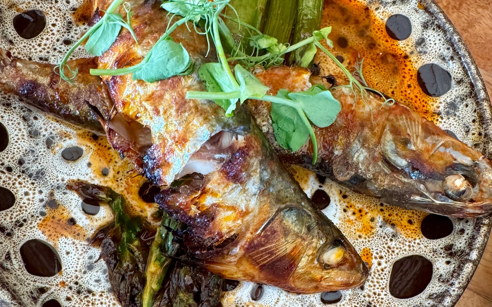 Baked fresh sardines in paprika honey butter with charred greens at The Bank at Bude