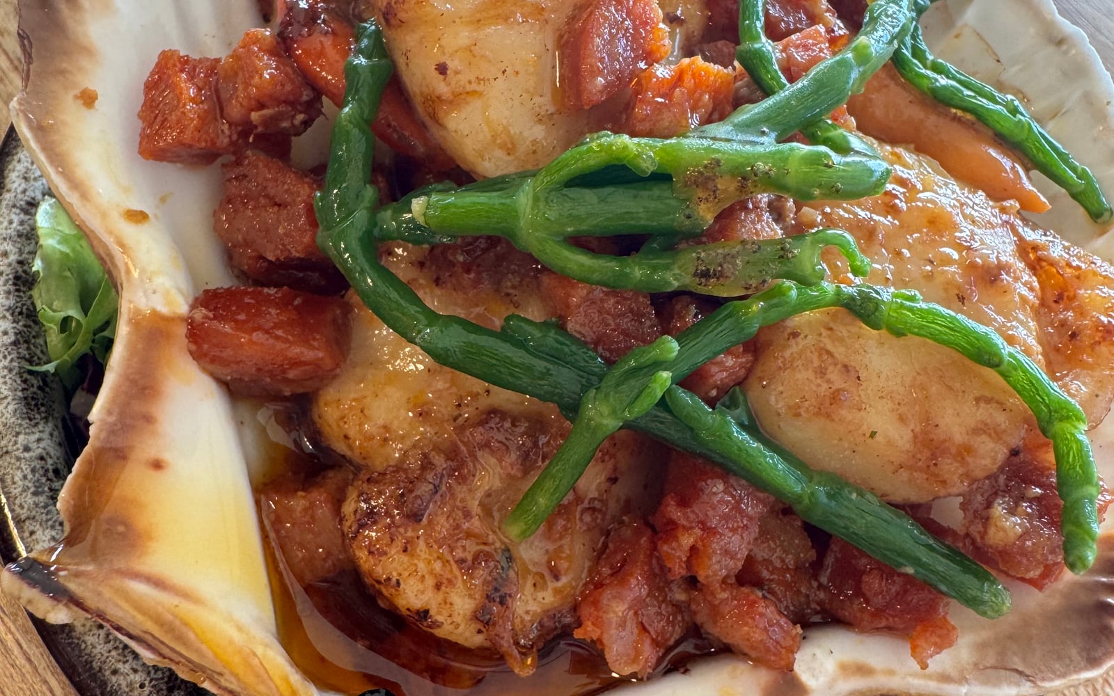 Pan-seared scallops with diced Spanish chorizo and samphire served in a scallop shell at The Bank at Bude