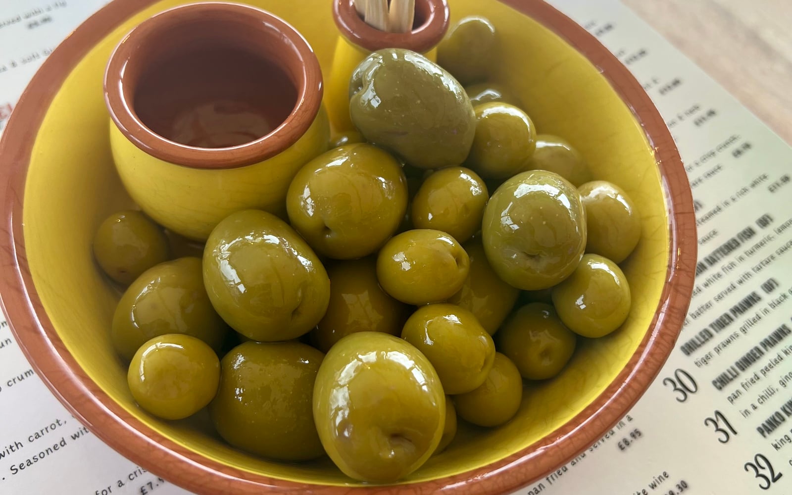 A terracotta dish of mixed Manzanilla and Gordal Spanish olives at The Bank at Bude