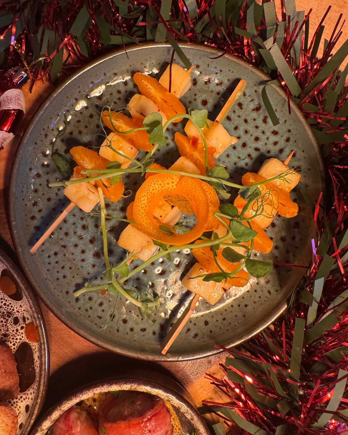 Grilled halloumi and clementine skewers on a plate at The Bank at Bude