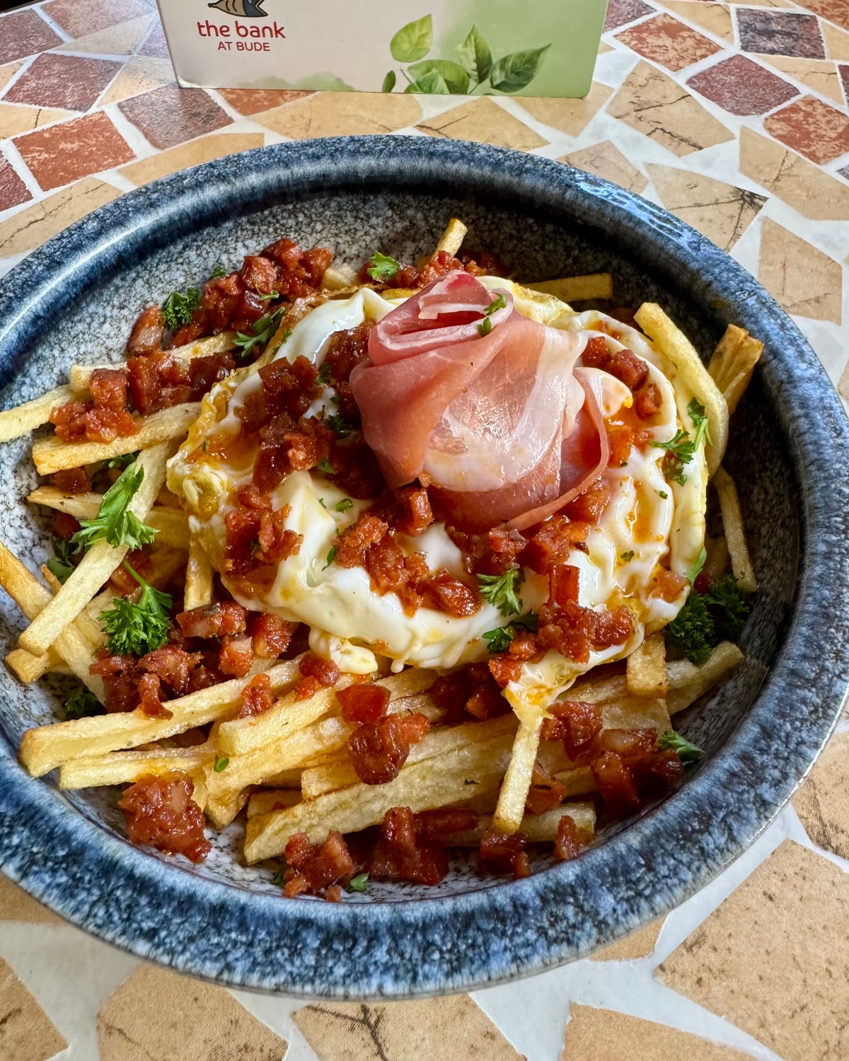 Serrano ham over a fried egg and chips with crispy chorizo at The Bank at Bude